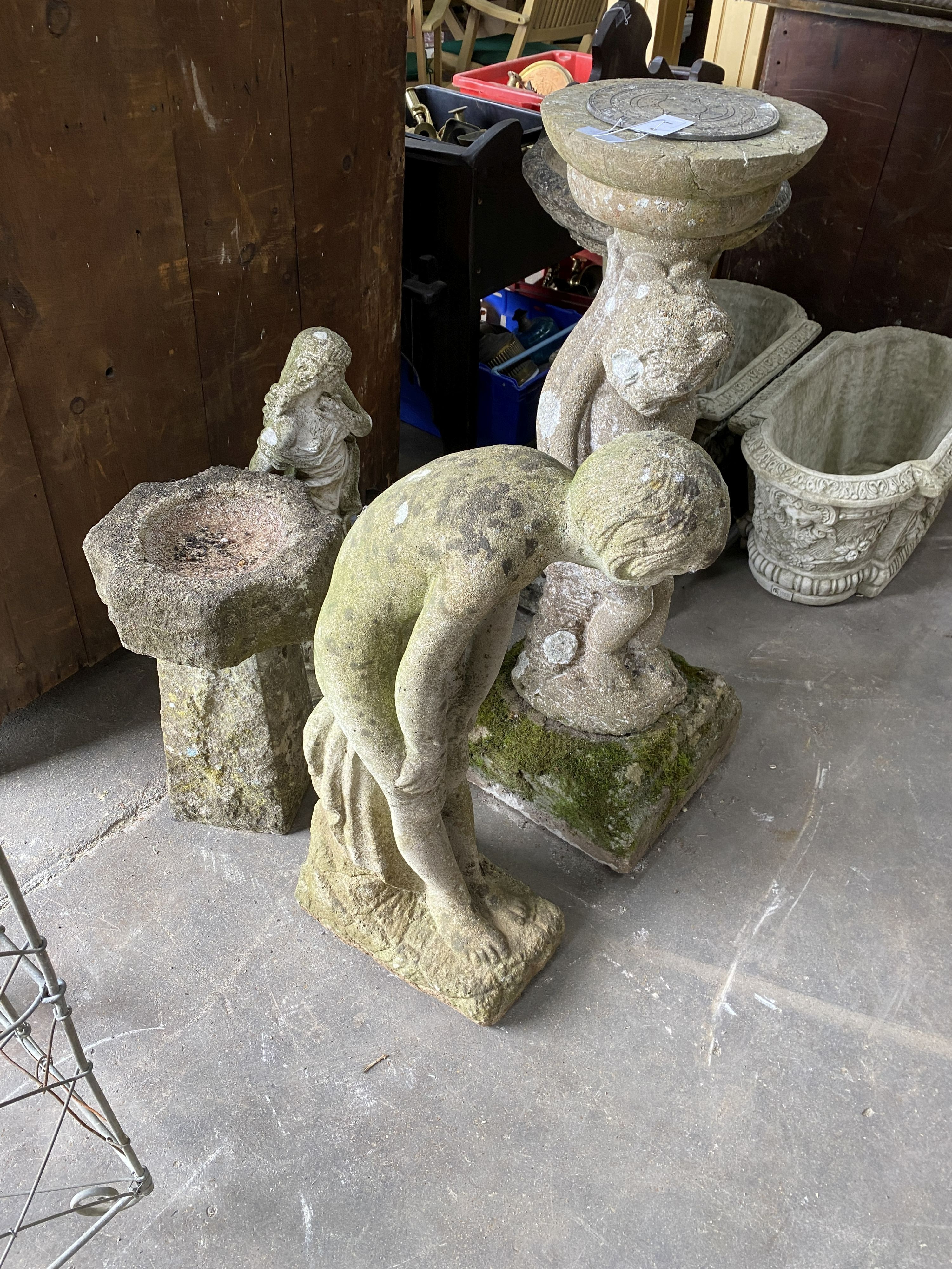 A reconstituted stone figural sundial, a female bather figure, bird bath and one other garden ornament, largest height 98cm